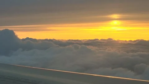 View from the window of the airplane to the beautiful cloudy sunset Stock Footage 311030130