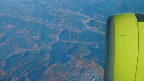 View from window of airplane, engine turbine, plane flying over mountains Stock Footage 170323173