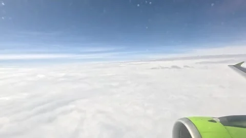 View from the window of the airplane. Flying above the clouds. Stock Footage 300175179