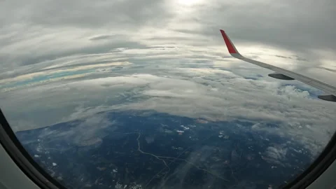 View from window of airplane flying high above lot of fluffy clouds. Timelapse Video stock 245567407