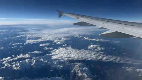View from the window of airplane flying over the Alps Stock Footage 227134651