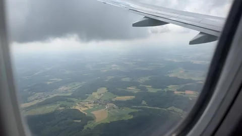 View from window of airplane flying over Bavaria, Germany in summer Stock Footage 246355803
