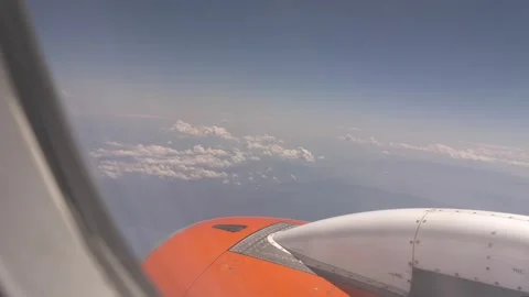 View from the window of an airplane on part of it and white clouds above the Stock Footage 258815103