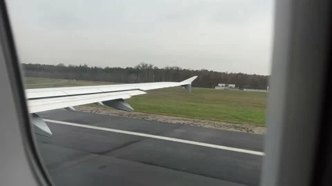 View from window of airplane taking off in Frankfurt airport in December Stock Footage 226972971