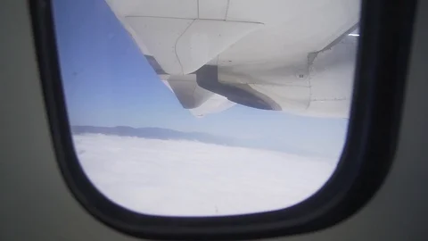 The view from the window - an airplane wing and a turbo engine in flight above Video stock 116817653