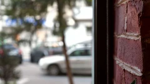 View from the window: a blurred city street and the texture of a brick wall Stock Footage 346407680
