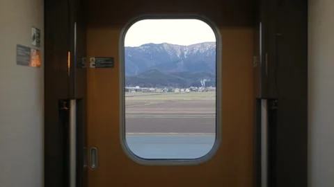 View to window on board at bullet high speed train's door with natural moun.. Vídeo Stock 328102065