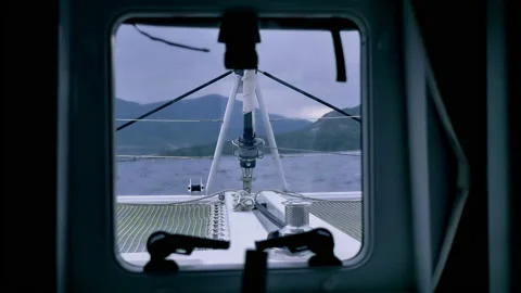 View from the window on the bow of a yacht sailing through the blue sea towards Stock Footage 221720538