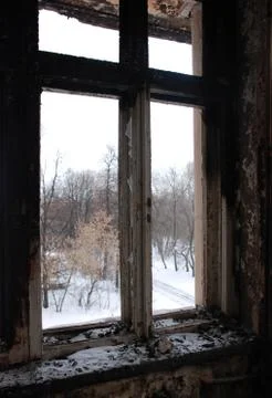 The view from the window of the burnt old building in winter. Stock Photos