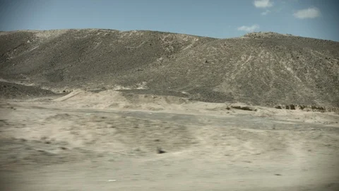 View from the window of a bus driving along a road in Egypt. Sandy desert landsc Stock Footage 122283093