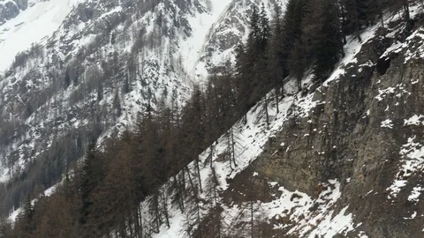 View from window cabin on cable car moving over winter mountain slope and peaks Video stock 82852371
