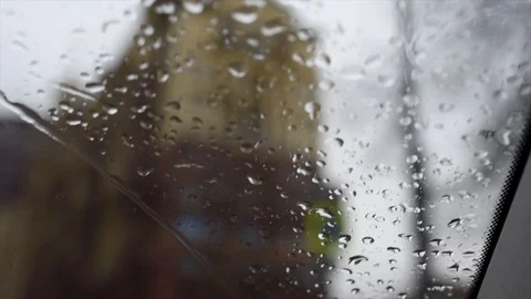 View from the window of a car driving down the street in the rain Stock Footage 120142844