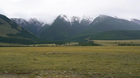 View from the window of the car to the mountains and the steppe Vidéo 94038796