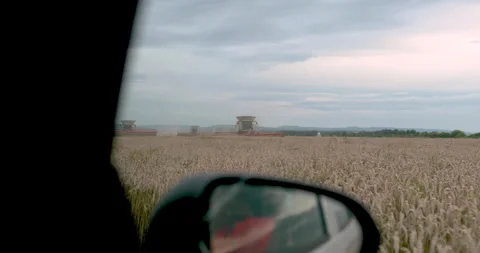 View from the window of a car moving along a field on which work Stock Footage 254820926