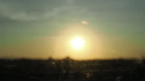 View from the window of a car moving along the road at sunset. the sun is settin Stock Footage 286025812