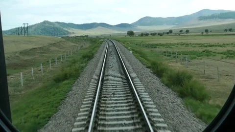 A view from the window of the car of a moving train on an escaping landscape. Stock Footage 81576976