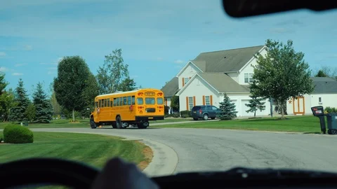 View from the window of the car, which goes after the school yellow school bus Stock Footage 97289186