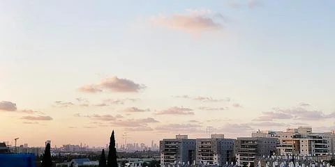 View from the window. The city at sunset 库存照片