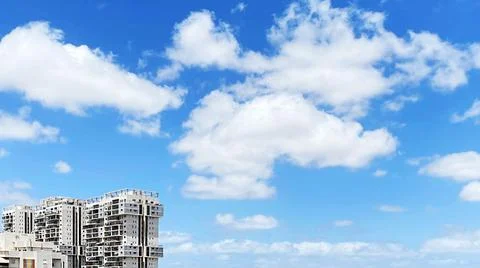 View from the window. City view over blue sky and white clouds 写真素材