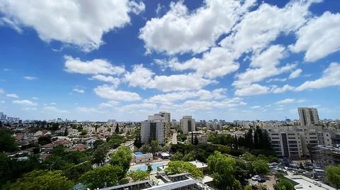 View from the window. City view over blue sky and white clouds Stock Photos