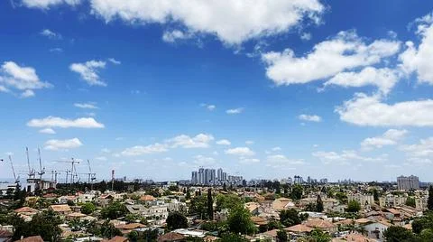 View from the window. City view over blue sky and white clouds Photos