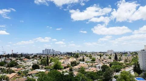 View from the window. City view over blue sky and white clouds 库存照片