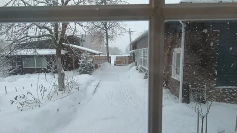 View from the window to the courtyard in winter as it snows Vídeo Stock 167741023