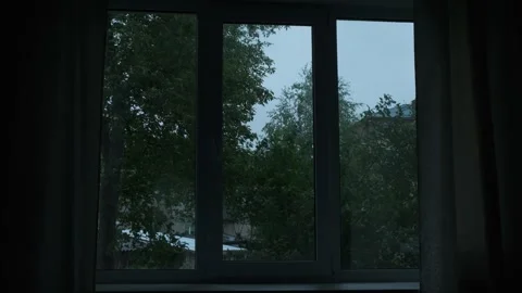 View from window of dark room. Evening or night green landscape with trees swayi Video stock 247177652