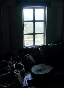 View from window in dark room full of old, empty baskets. Stock Photos