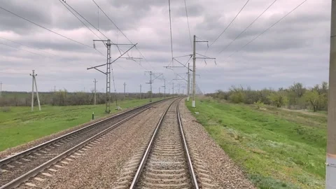 View from window of driver of moving train through rural areas, railways Video stock 242449294