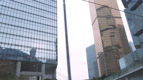 View from window driving passenger bus to glass facade business skyscrapers in Stock Footage 108642625