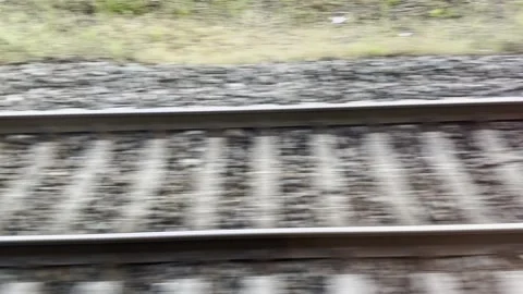 View from the window of fast moving train looking down at parallel railway track Stock-Footage 331035584