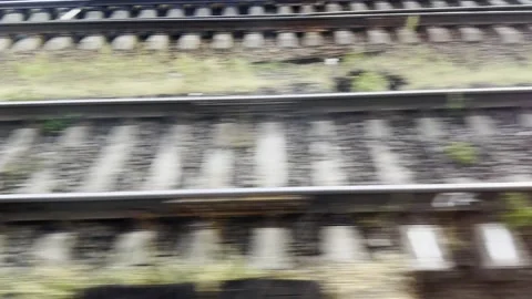 View from the window of fast moving train looking down at parallel railway track Stock Footage 334339094