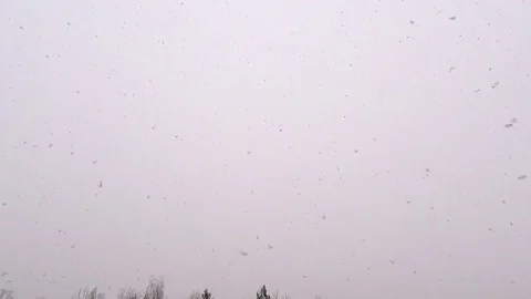 The view from the window on the flying of large fluffy snow Stock Footage 85114351