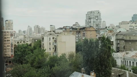 View from the window from a high floor showing a bright cityscape with a touch Stock Footage 308395404