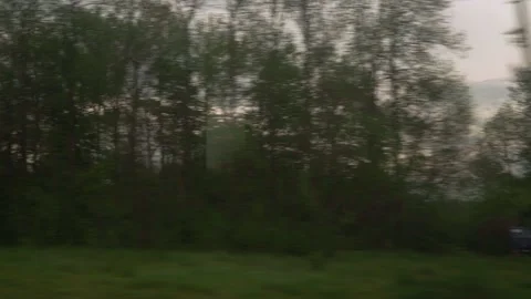 View from window of high-speed train on landscape of beautiful nature field road Stock Footage 156176815