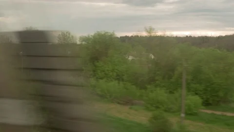 View from window of high-speed train on landscape of beautiful nature wild field Stock Footage 156176869