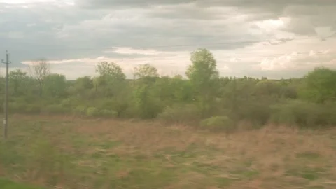 View from window of high-speed train on landscape of beautiful nature wild field Stock Footage 156268867