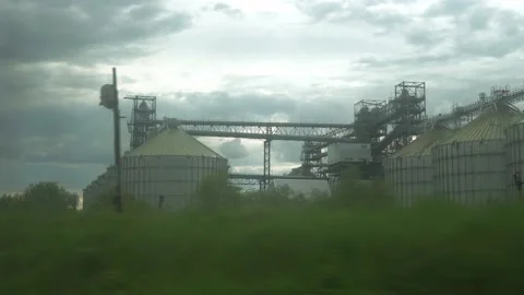 View from window of high-speed train on landscape of old rusty boxcars and steel Stock Footage 156483073