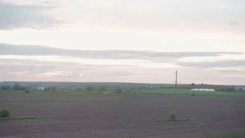 View from window of high-speed train on landscape of beautiful nature field Stock Footage 156821397