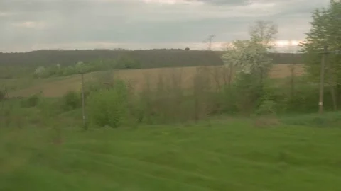 View from window of high-speed train on landscape of beautiful nature wild field Stock Footage 156938199
