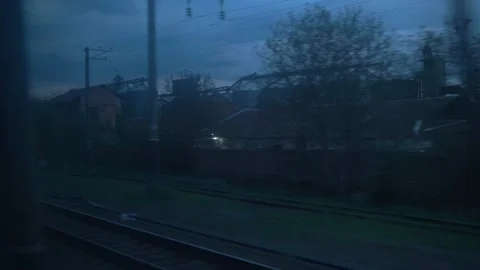 View from window of high-speed train on landscape of old rusty boxcars and steel Video stock 156983672