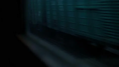 View from window of high-speed train on landscape of old rusty boxcars and high Stock Footage 157130347