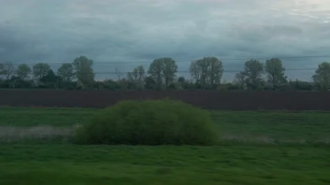 View from window of high-speed train on landscape of beautiful nature wild field Stock Footage 157184809