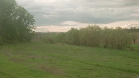 View from window of high-speed train on landscape of beautiful nature wild field Stock Footage 157293510