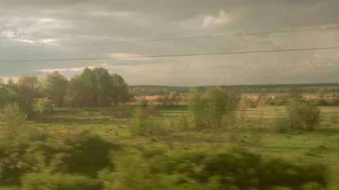 View from window of high-speed train on landscape of beautiful nature wild field Stock Footage 157403589