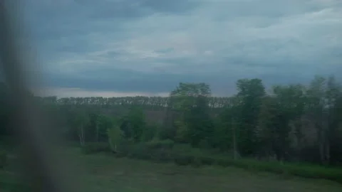 View from window of high-speed train on landscape of beautiful nature wild field Stock Footage 157404131