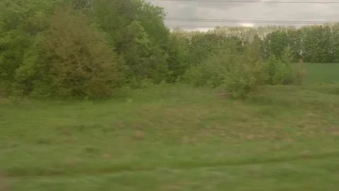 View from window of high-speed train on landscape of beautiful nature wild field Video stock 157510483