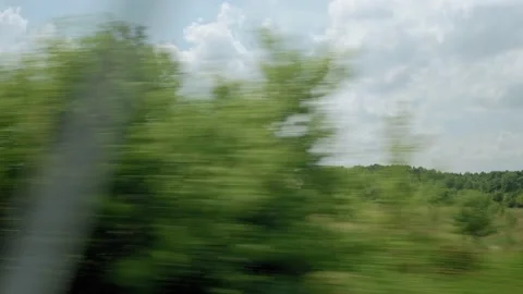 View from window of high-speed train on landscape of beautiful nature wild field Stock Footage 157610387