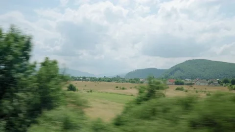 View from window of high-speed train on landscape of beautiful nature wild field Stock Footage 157656100